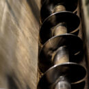 Close up image of a screw conveyor in motion.